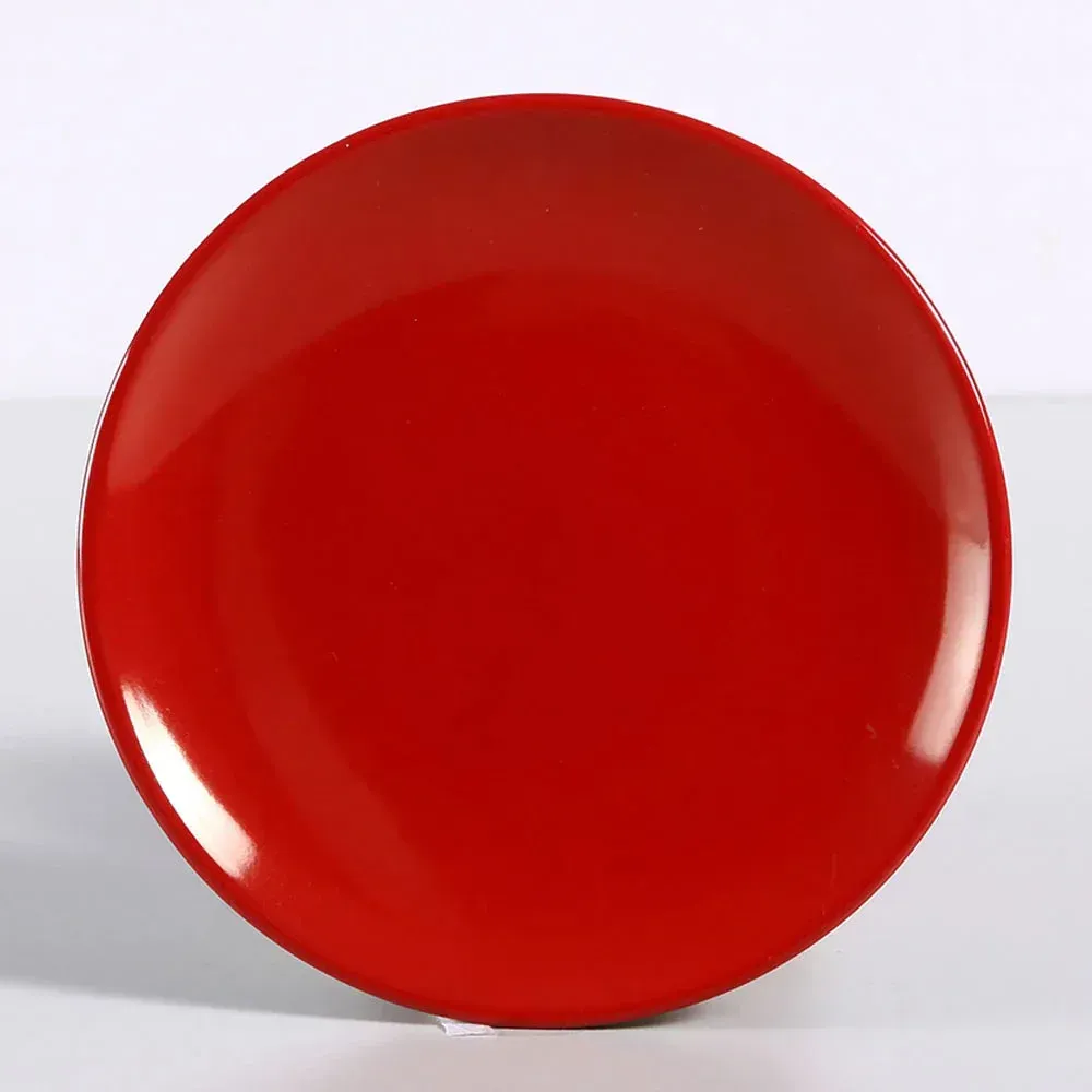 Small round melamine coupe plate in a glossy red finish from Yanco China, a durable and break resistant option for serving side dishes or small bites.