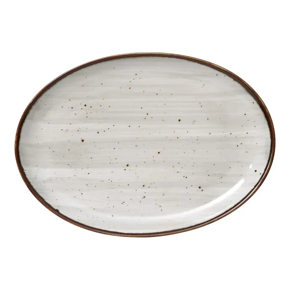 Very small oval coupe platter by Yanco China with a rustic, speckled finish, an ideal and artistic choice for serving bread, butter, or amuse bouche.