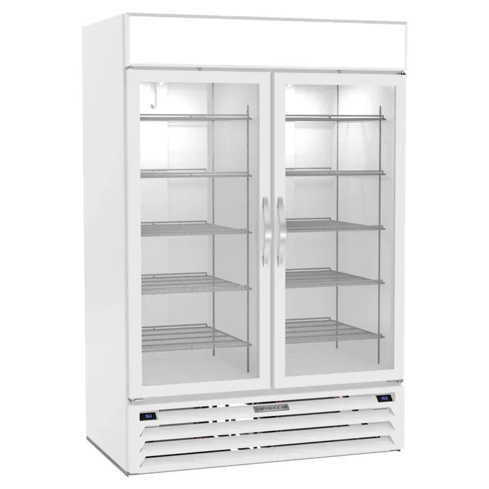 Beverage-Air white glass door dual-temp merchandiser glowing under bright LEDs, sleek frame on retail floor with chilled and frozen items visible.