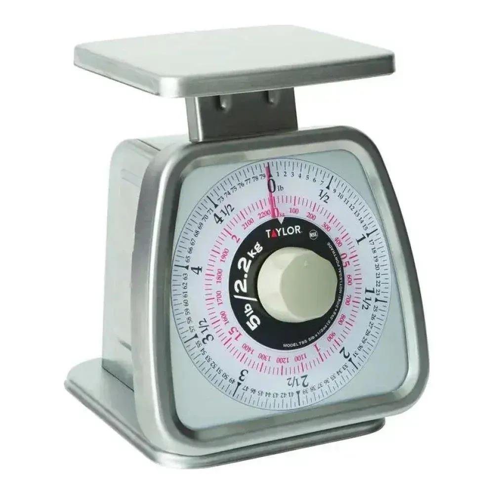 Taylor dual scale with rotating dial offers precise mechanical weighing for ingredient portioning in commercial foodservice operations.