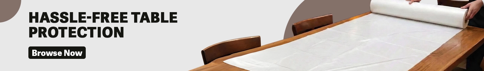 Disposable table cover roll being placed on a dining table for easy protection in restaurants, cafés, and banquet halls.