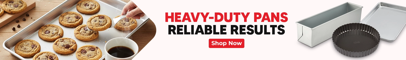 Freshly baked cookies on a sheet pan with baking pans displayed alongside a banner promoting heavy-duty pans for reliable results.